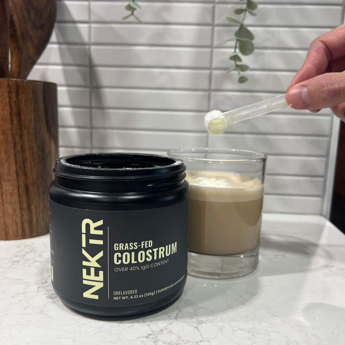 Colostrum supplement powder alongside a post-workout recovery meal, highlighting its role in supporting muscle repair, reducing inflammation, and enhancing overall recovery