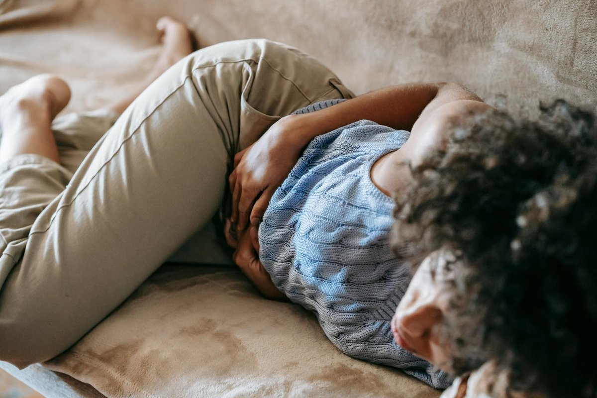 Woman experiencing stomach discomfort